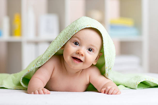 istock Smiling baby after shower or bath with towel on head 540566948