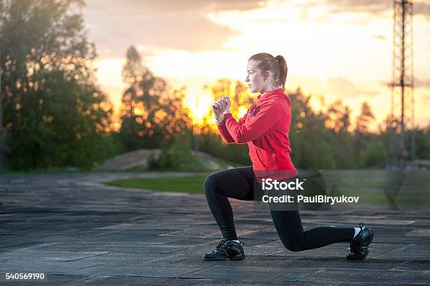 Woman In Sportswear Doing Squats Outdoors Stock Photo - Download Image Now - Only Women, Squatting Position, Women