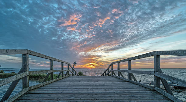 istock Wooden Bridge over lake and majestic cloudscape at sunset 540569596