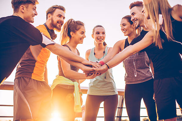 Team for the win Group of athletes prepere for workout, they cheering themself for good teamwork. healthy lifestyle women outdoors athlete stock pictures, royalty-free photos & images