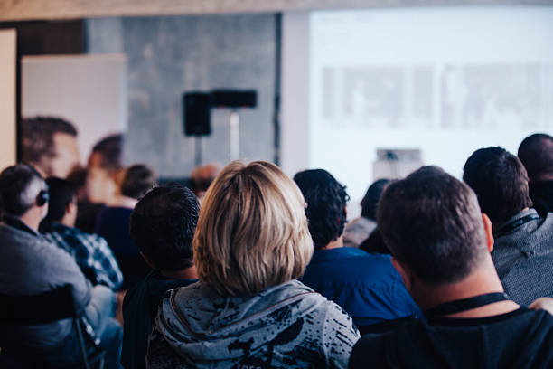 Business Conference Audience people sitting rear at the business seminar on the screen in Conference Hall. lecture hall training classroom presentation stock pictures, royalty-free photos & images