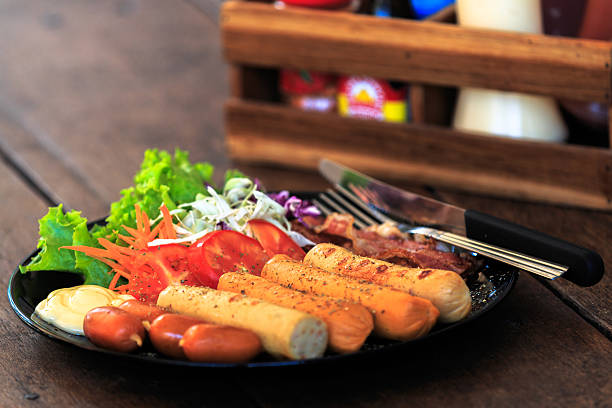 Sausages & Hot Dog Combo Cooking: Grilled sausages, sauce on the table close-up.