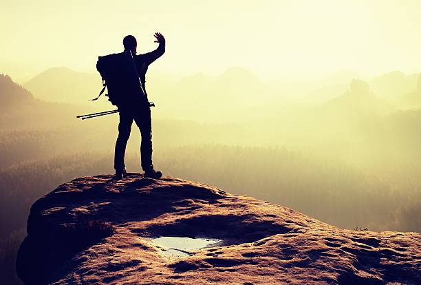 istock Hiker  with poles in hand shadowing eyes, spring daybreak 540573062