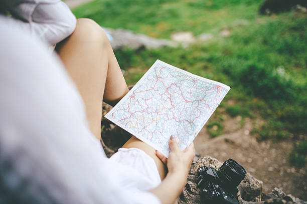istock woman holding a map in the park 540575422