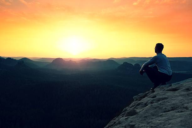 istock Hiker sit on cliff and enjoing spring view in mountains 540575822