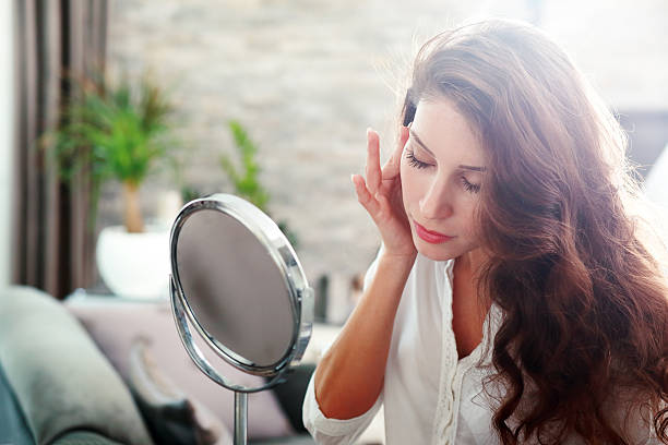 istock woman looking in the mirror 540577468