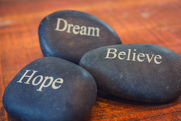 istock Black inspirational pebble stones with words 540579268