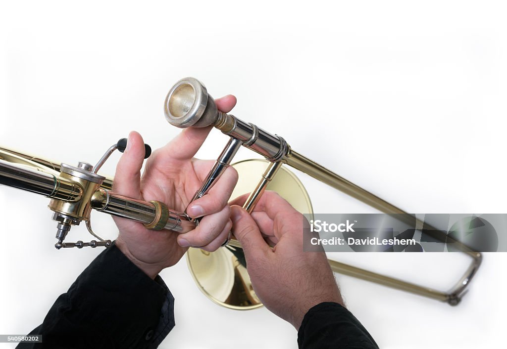 Trombone musician Close-up - Golden trombone and musician's hands Mouthpiece Stock Photo