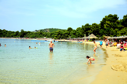 Skiathos, Greece, June 18, 2014.  Holidaymakers enjoying a bathe and the sun,sea and sand of the popular Koukounaries beach.
