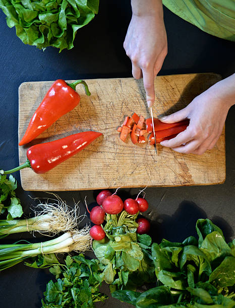 istock Female slicing pepper for salad. Close up chef cutting vegetabl 540582440