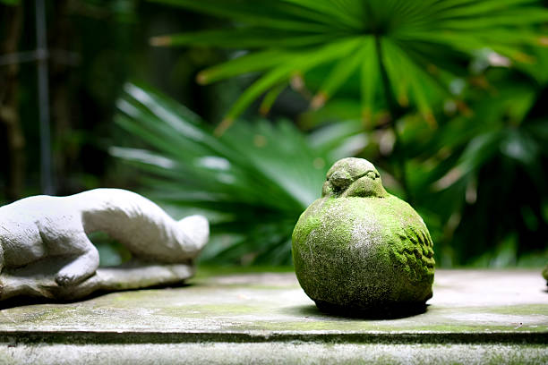 Old Cement statues bird in the green garden