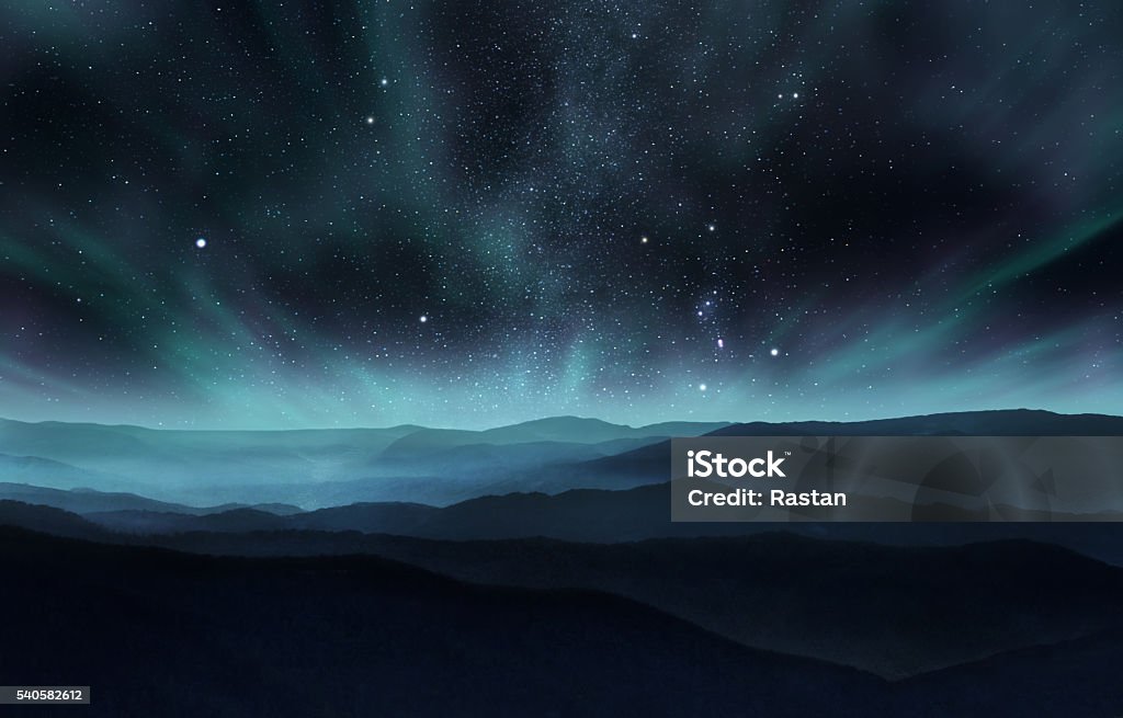 Northern lights Starry night sky with aurora over the hills Night Stock Photo