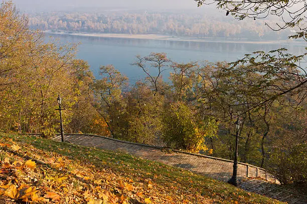 Brick-paved Path and Lanterns on Hillslope under Morning Sun on Autumn Day