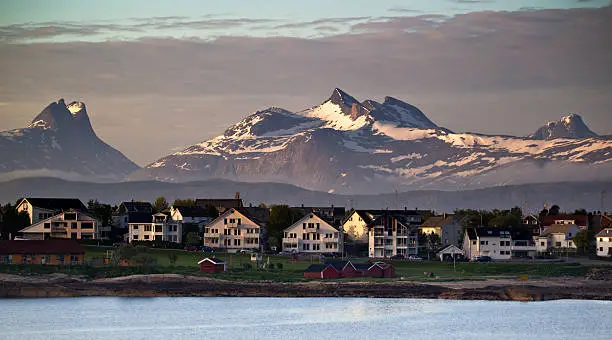 Just outside the harbor of Bodø, Norway, looking toward the southeast.  Mountain peaks rise to more than 1000 metres (3,300 feet). Bodø's population approximates 50,000. it is located 80km (50 miles) north of the Arctic Circle.