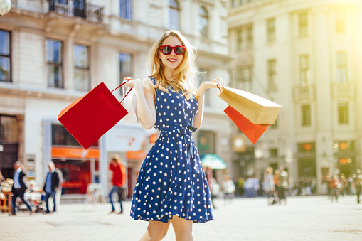 Beautiful, blonde woman is shopping in the city