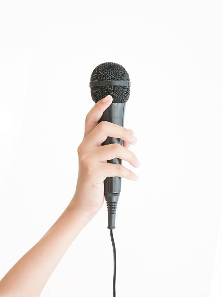 istock Female beauty hand holding microphone on white background 540587744