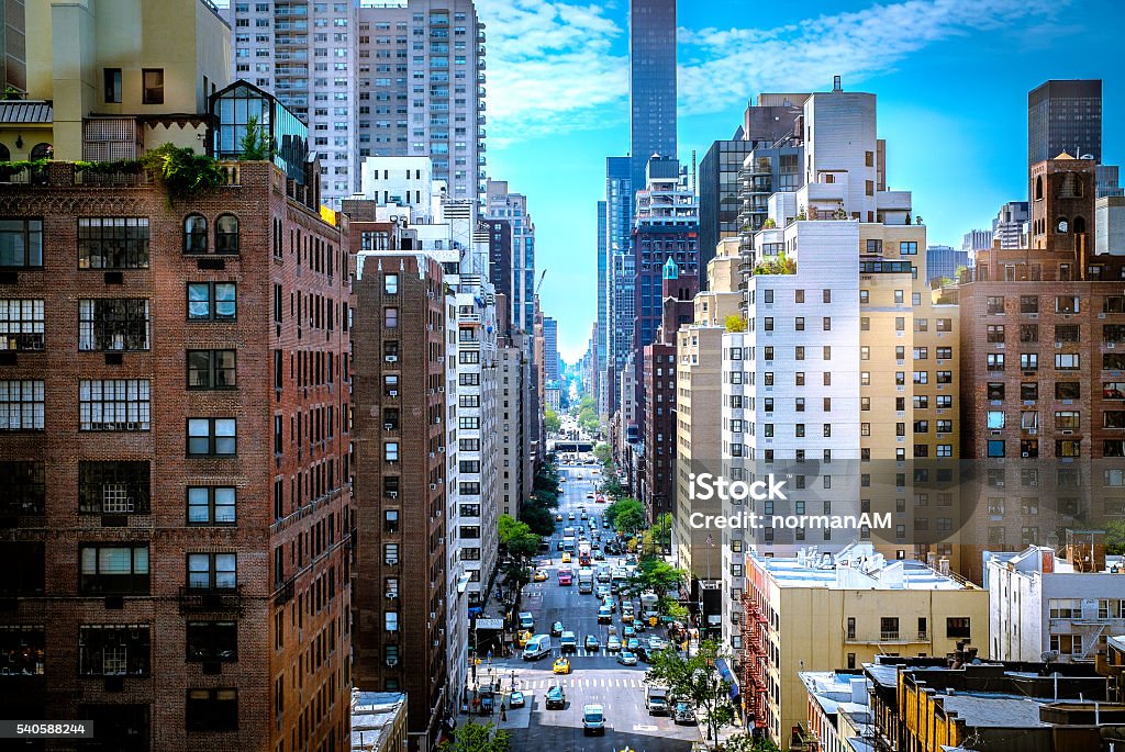 New York City - Colorful Street Canyon A colorful street canyon in New York City. The blue sky along with some clouds build a nice background for the busy street. New York City Stock Photo