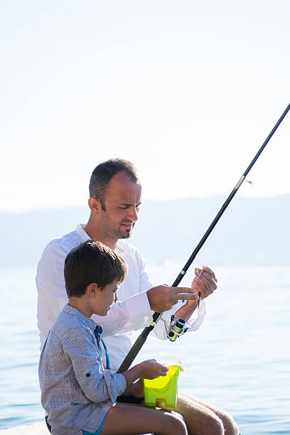 istock Father and son fishing 540590218