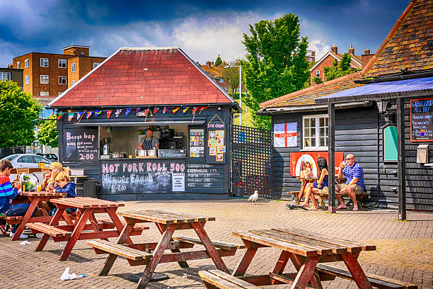 People sitting outside a hot food shack in Folkstone, UK Folkstone, UK - June 25, 2012: People sitting outside a hot food shack in Folkstone, UK sandwich kent stock pictures, royalty-free photos & images