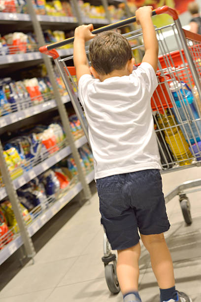 istock Boy Pushing a Grocery Cart 540597246