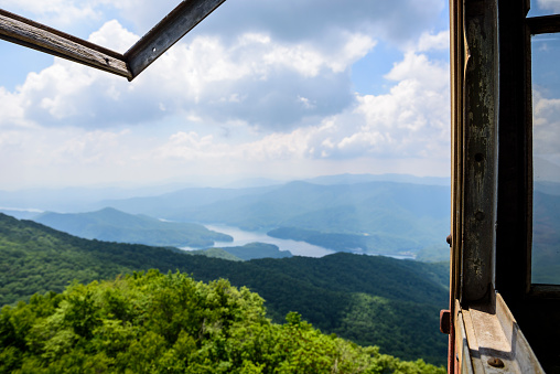 View from the abandoned Shuckstack Fire Tower in the Great Smoky Mountains National Park. In the center is Fontana Lake. The fire tower was constructed in 1934 by the Public Works Administration and is located one-tenth of a mile from the Appalachian Trail.