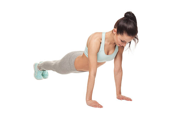 istock athletic woman doing push-ups on a white background 540598278