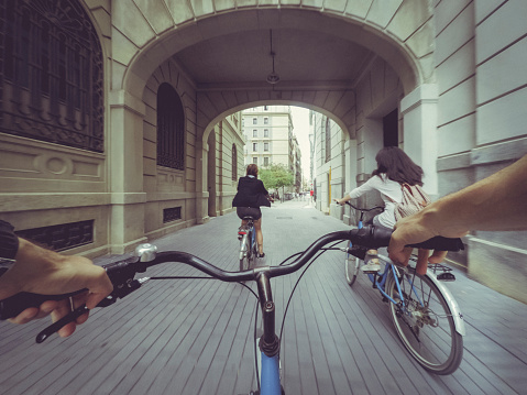 POV bicycle riding with two girls in the city