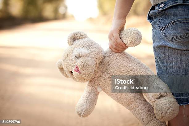 Runaway Or Lost Girl Holding Old Ragged Teddy Bear Stock Photo - Download Image Now