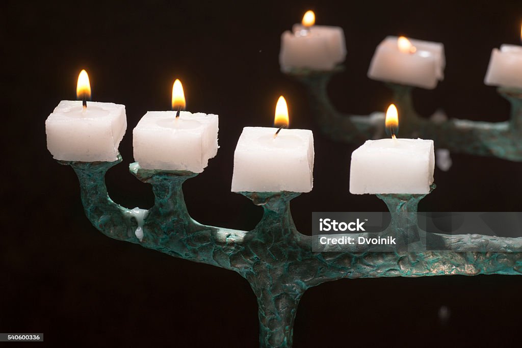 small candles burning on a copper candlestick Burning Stock Photo