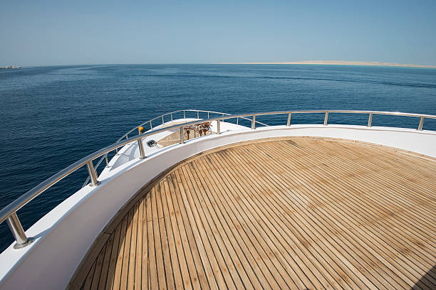 View over the bow of a large luxury motor yacht on tropical open ocean
