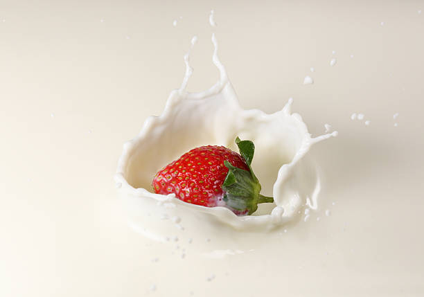 istock Splashing Strawberry into Milk 540606638