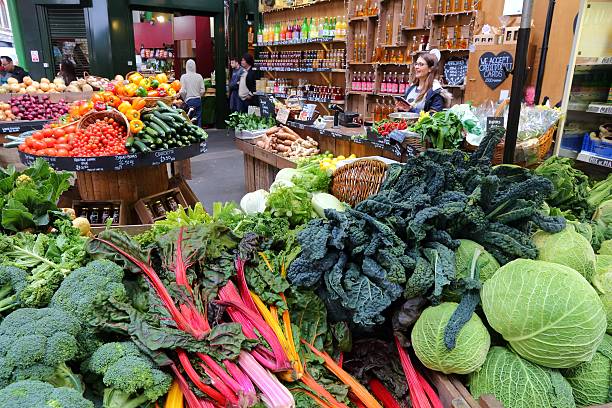 London Borough Market London, UK - April 22, 2016: People shop at Borough Market in Southwark, London. It is one of oldest markets in Europe. Its 1,000th birthday was in 2014. borough market stock pictures, royalty-free photos & images