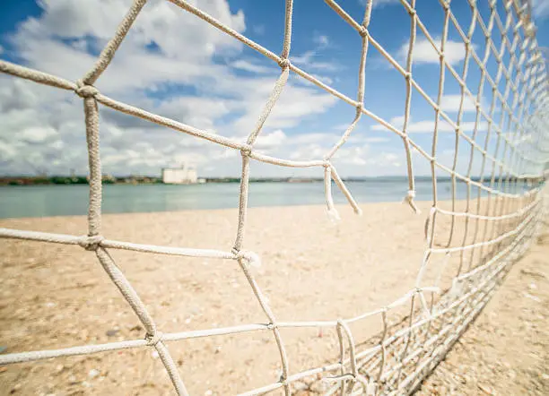 Torn, broken, fishnet at beach