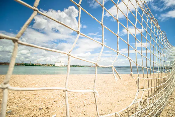 Torn, broken, fishnet at beach