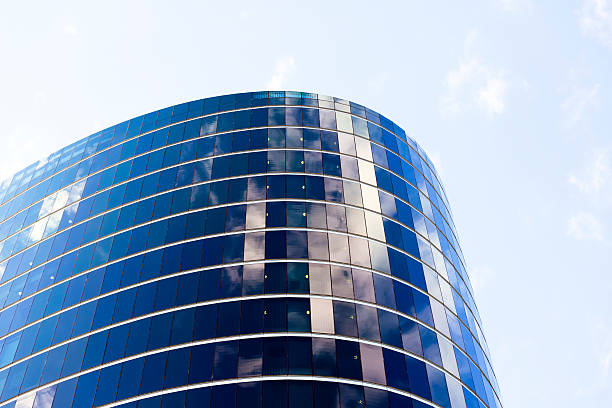 istock Futuristic glass office building with reflection of sky, copy space 540610536