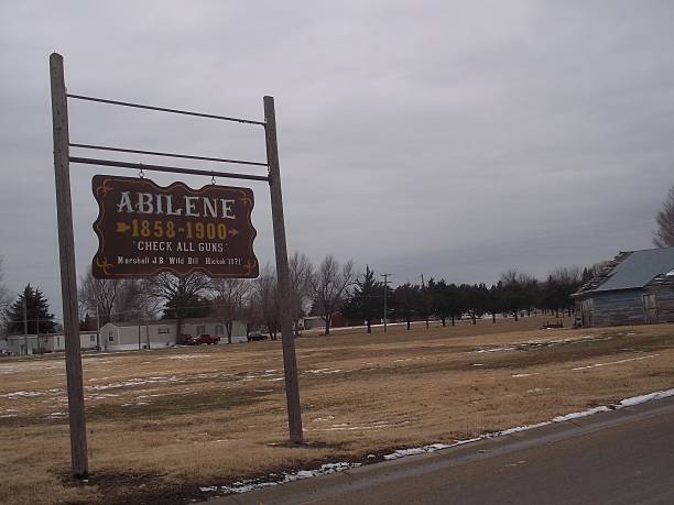 Abilene Check All Guns Sign An old fashioned sign along a road in Abilene, Kansas saying to "check all guns". abilene texas stock pictures, royalty-free photos & images