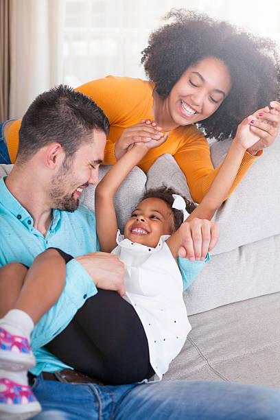 allegro giovane famiglia a casa. - child candid indoors lifestyles foto e immagini stock