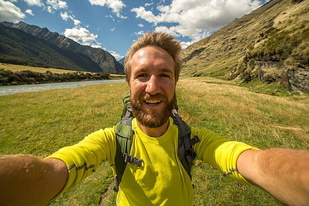 istock Young man takes self portrait in mountain valley 540612286