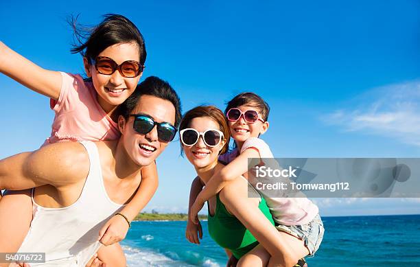 Happy Family Having Fun At The Beach Stock Photo - Download Image Now - Family, Asian and Indian Ethnicities, Vacations