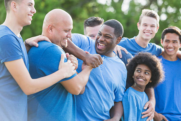 istock Multi-ethnic group of men and sons in blue shirts 540717118