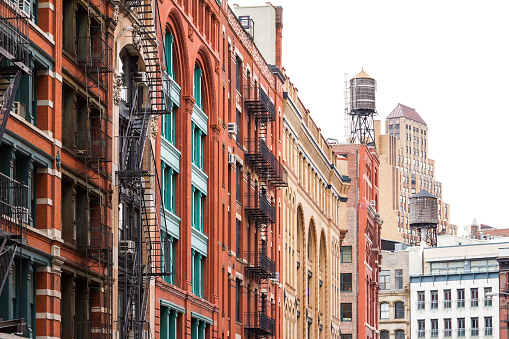 Block of buildings with fire escapes and water towers in Soho Manhattan, New York City