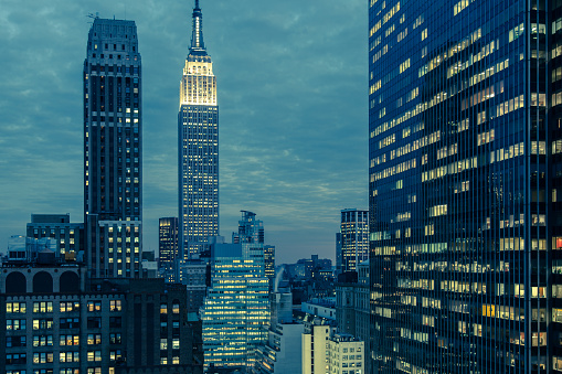 Horizontal cool toned early evening view of mid-town Manhattan and Empire State Building in NYC