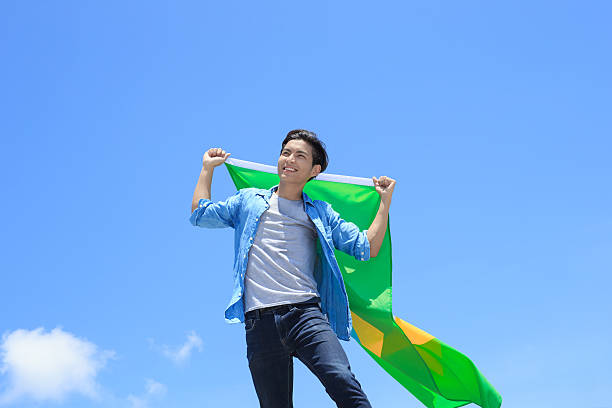 istock Excited man holding brazil flag 540721104