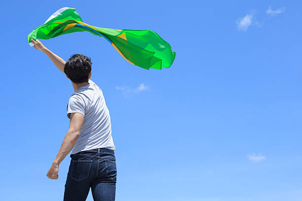 istock Excited man holding brazil flag 540721280