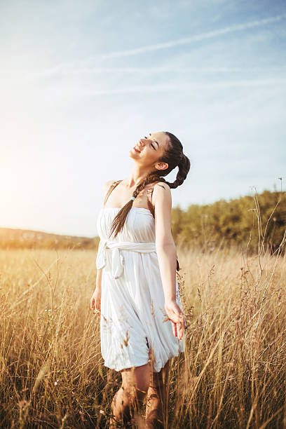 istock Pretty young woman in field at sunset 540723670
