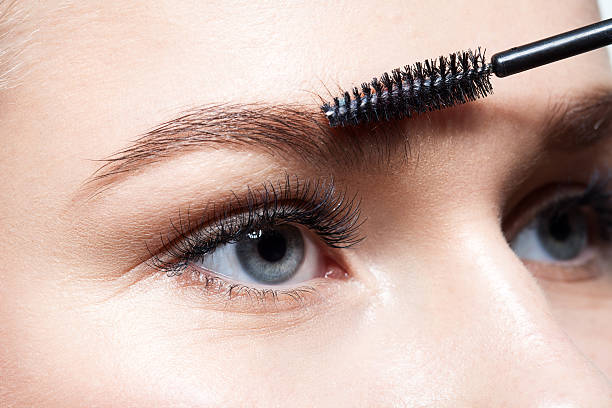 istock Closeup of woman doing makeup eyebrow brush 540724392