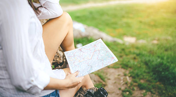 istock woman holding a map in the park 540724764