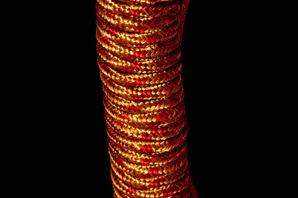 istock Gold and metallic red rope showing textures 540728870