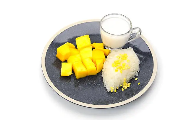 Photo of mango sticky rice with coconut milk place on plate