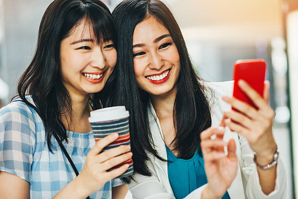 istock Girlfriends looking at a smart phone 540731280